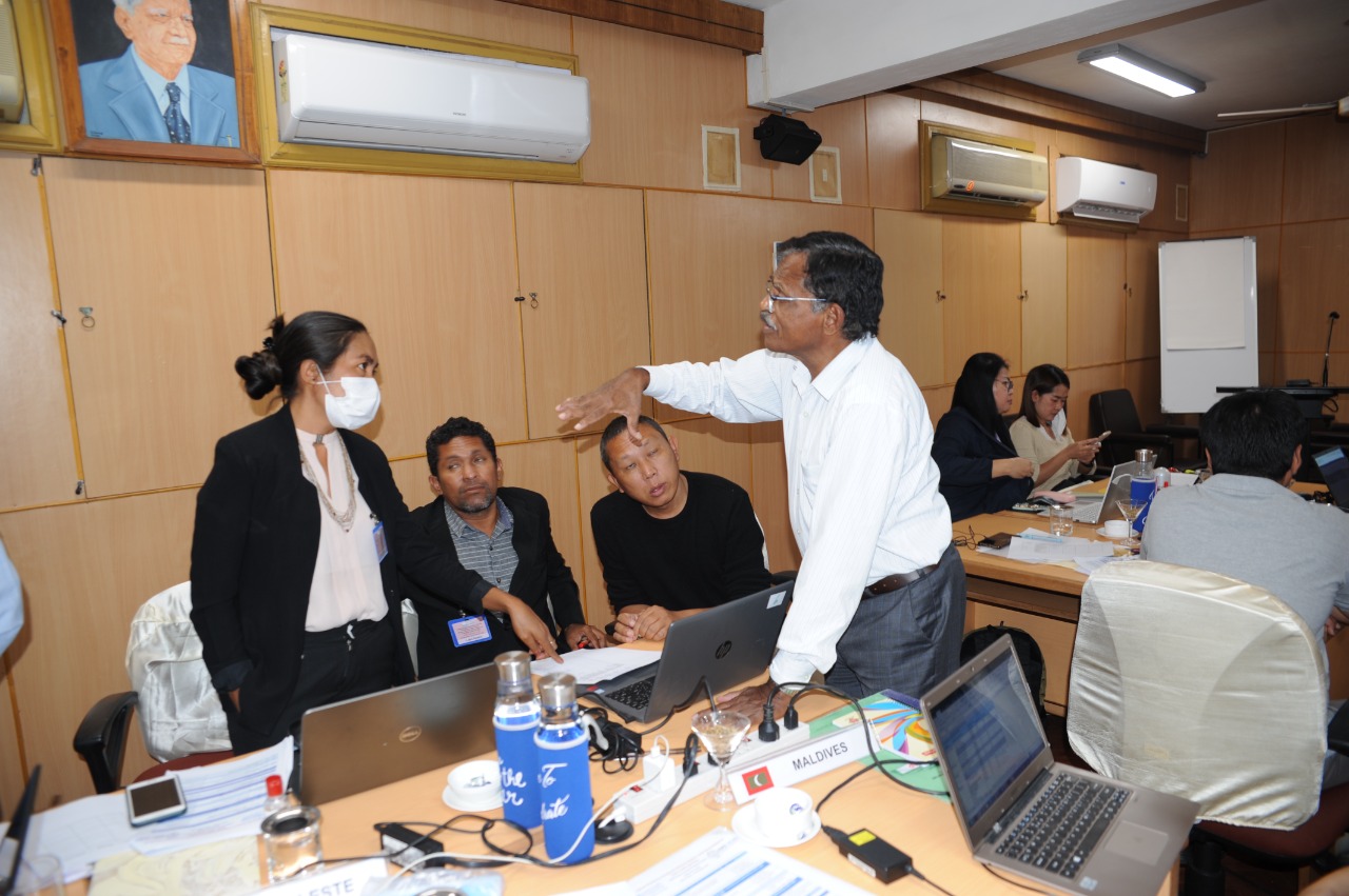 Participants in group work, supported by facilitators